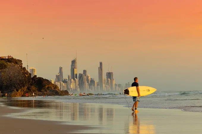 Gold Coast beach lifestyle with surfer at sunset