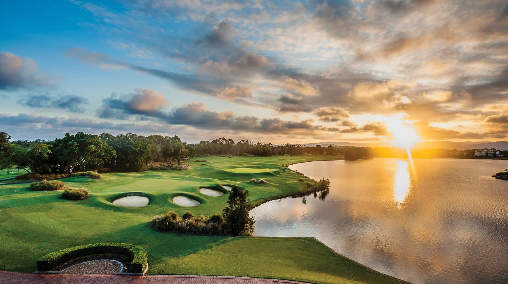 Links Hope Island golf course at sunset with championship greens and water features